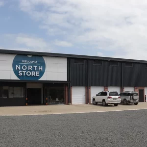 Entrance to North Store with luxury SUV in foreground