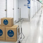 Three boxes arranged on a trolley in the North Store facility with secure units in the background