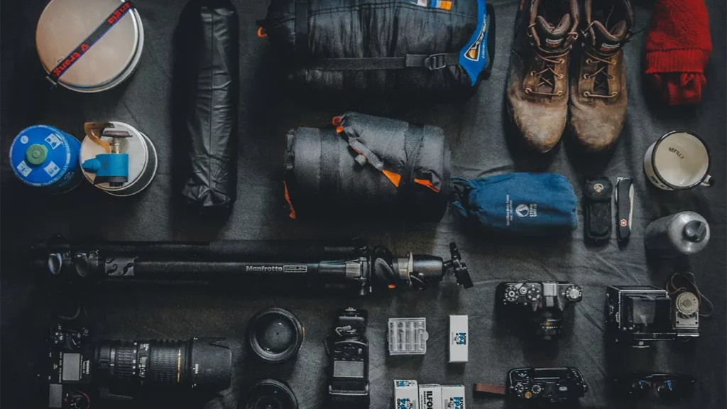 A neatly arranged collection of camping and adventure gear